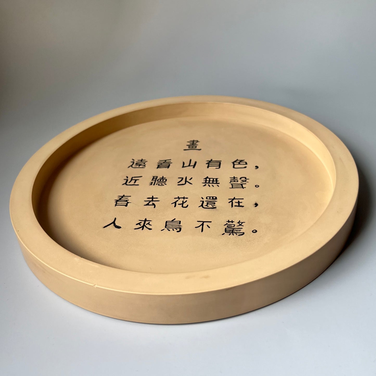 Chinese calligraphy on a shallow container made of gypsum